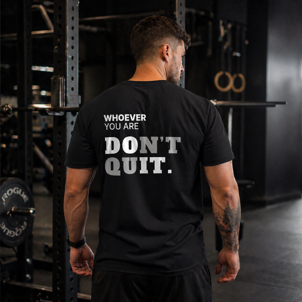 Person wearing a black Don’t Quit motivational t-shirt in a gym setting