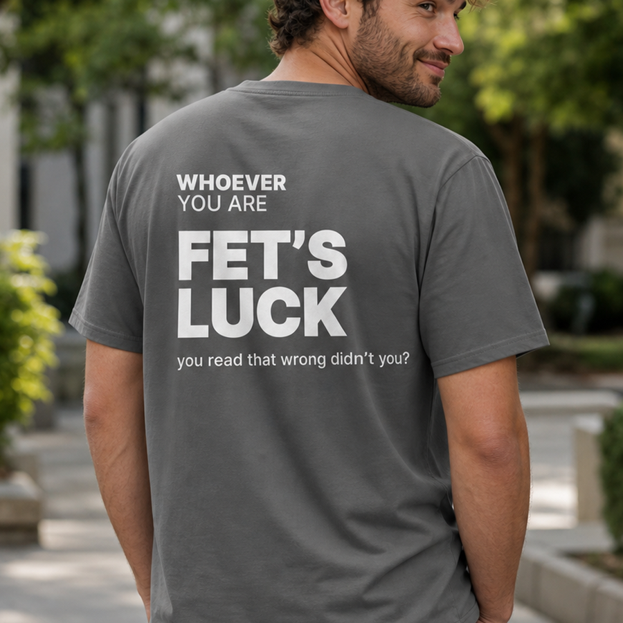 Person wearing a gray Fet’s Luck funny t-shirt with cheeky back print outdoors