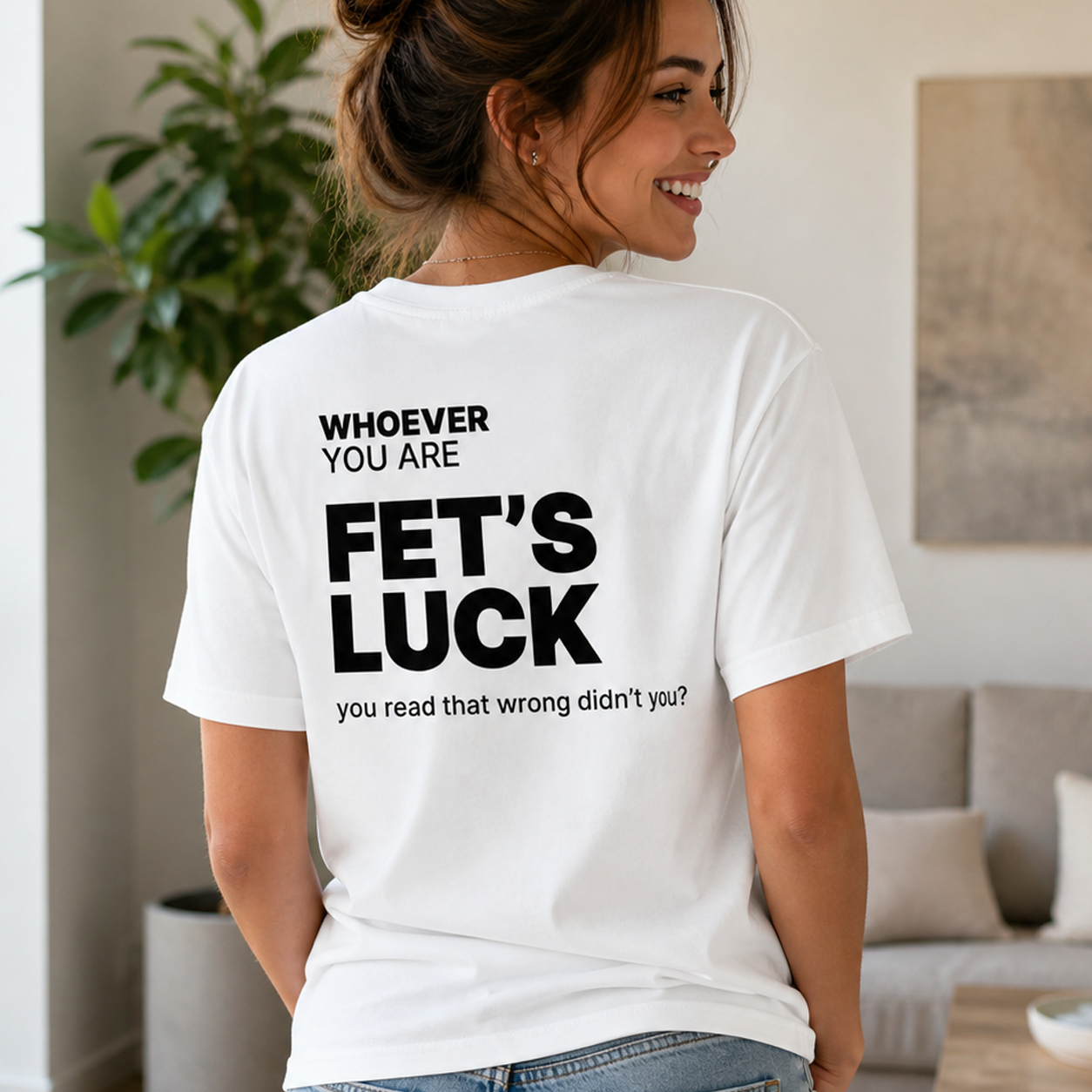 Person wearing a white Fet’s Luck funny t-shirt in an everyday setting with back print visible