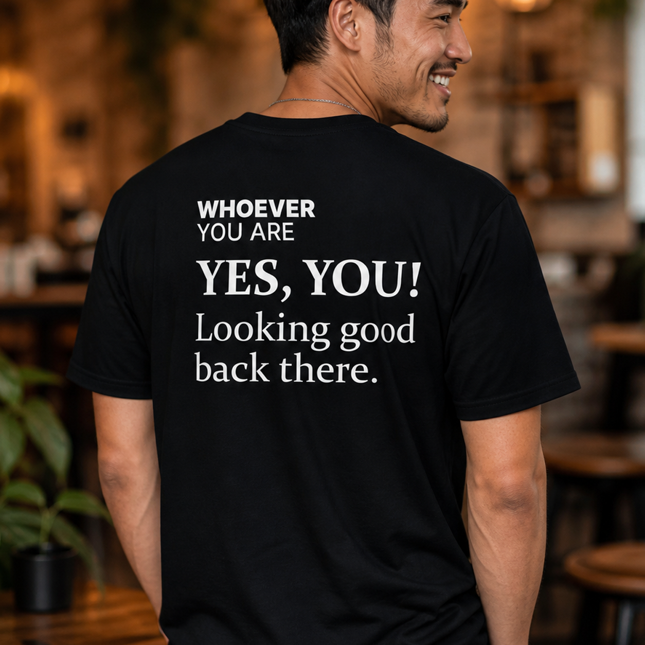 Person wearing a black Yes, You! Looking Good Back There funny t-shirt in an everyday setting