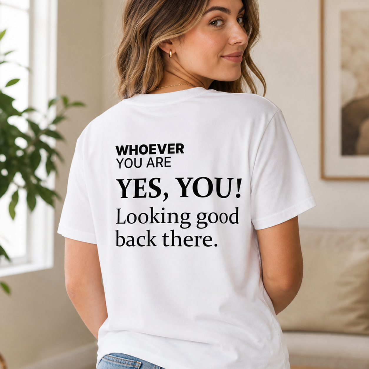 Person wearing a white Yes, You! Looking Good Back There funny t-shirt with back print at home
